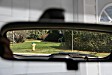 The view down our driveway in the rearview mirror. Compare with next photo..